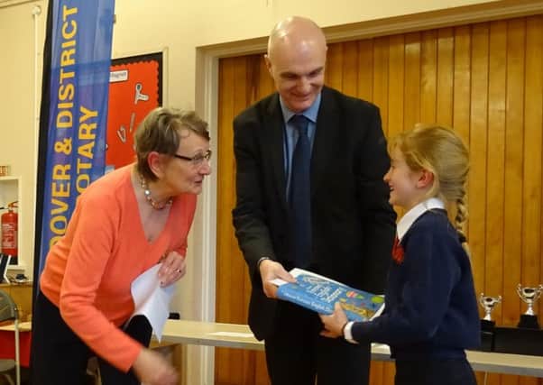 Wendover Rotary Christmas story competition -  Anne McCartin of Wendover Rotary, with winner Poppy Wybrow of Weston Turville CofE Combined School being presented her prizes by Phil Bannister of Harpenden Building Society