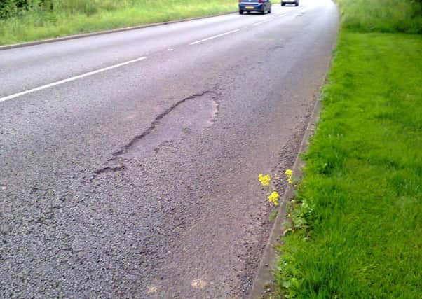 Editorial image showing potholes on the A421