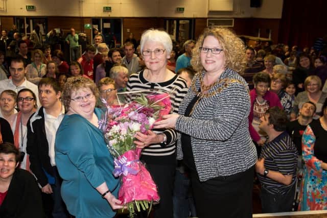 Presentation to Pam Sheppeck who founded the Aylesbury Gateway Club in 1982 for adults with learning difficulties. She is retiring in November. pictured is Nicky Reid  - one of the original club members presenting a bouquet to Pam, and mayor Alison Harrison PNL-160703-213246009