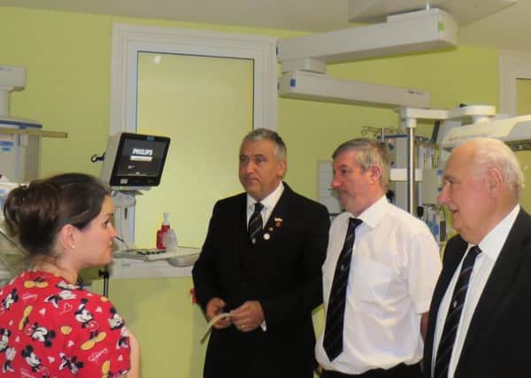 Sister Lisa Caldwell explaining some of the neonatal 
equipment to Martin Richardson (holding the cheque), Ian Dudley and 
Brian Richardson, all members of Misbourne Lodge of Freemasons.