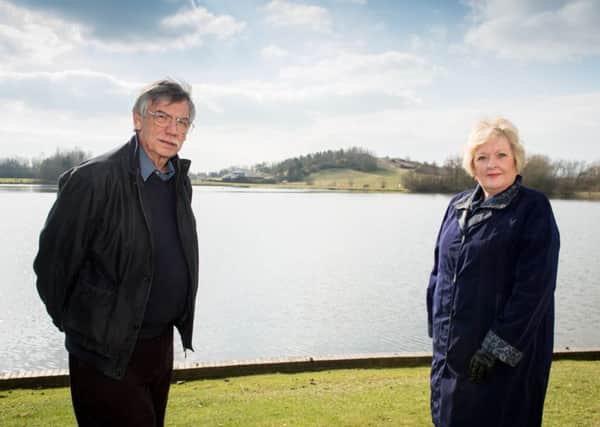 Site of the planned Watermead Crematorium, as seen from the adjacent side of the lake - pictured are Cllr Eric Rose and parish council chair Sue Severn