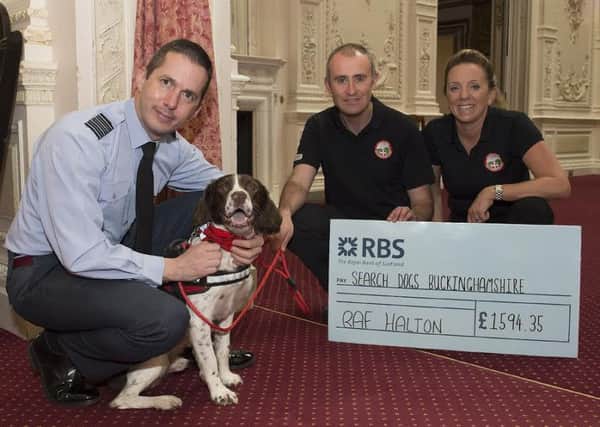 RAF Halton Donate ?1594 to Bucks Search Dogs.  Following a recent success of Beau the Dog finding a missing civilian, RAF Halton and the Stn Cdr gladly donate monies to the charity to support the local efforts.  The Cheque was received by Sgt Gaz Elliott and Sqn Ldr Ali Sanderman who are both serving personnel but also volunteer with their pet dog Beau with Search Dog Buckinghamshire. PNL-160420-170303001
