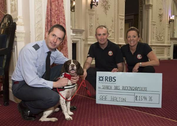 RAF Halton to Bucks Search Dogs -Station Commander with presents the cheque to Sgt Gaz Elliott and Sqn Ldr Ali Sanderman who are both serving personnel but also volunteer with their pet dog Beau.