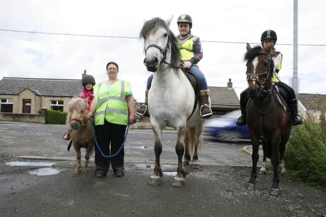 Joann Pollock complaining that drivers have no idea how to act when passing horses on the road. Lucy Corroon (7) on Halle; Lauren Hamilton on Merlin; Sophie Corroon (10) on Coco. NNL-160428-110627001