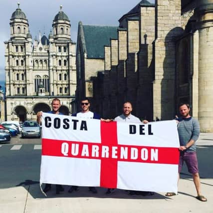 Adam Brooks, left, and friends with their Costa Del Quarrendon flag in France