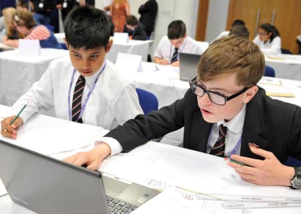 Tom Hinson (right) and Muhammad Moeen do their calculations ahead of the maths challenge PNL-160407-111150001