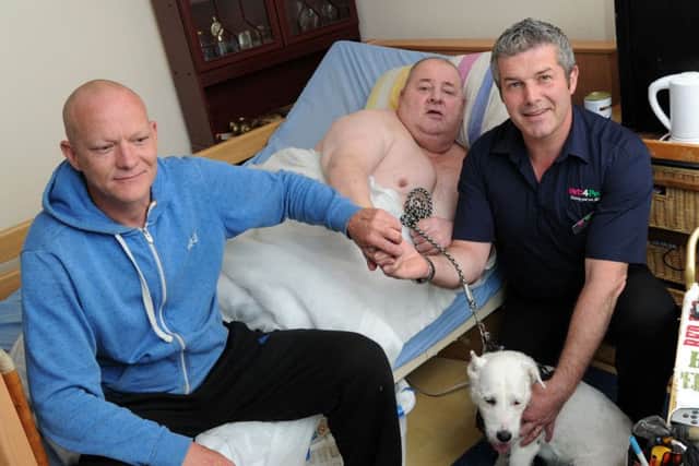 John Batey from Tingewick, centre, was trapped at home and was rescued by plumber, Rob McFetrich, left and vet manager, Michael Docherty, right. PNL-160707-140925009