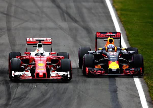 Daniel Ricciardo makes a move on Ferrari's Sebastian Vettel