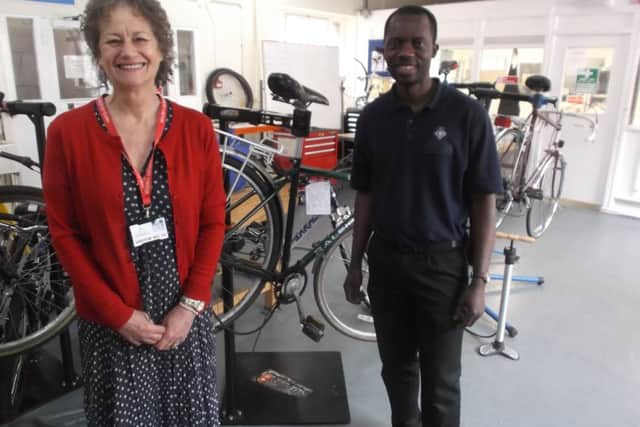 Young prisoners at atÂ HM Young Offenders InstituteÂ in Aylesbury have been repairing bicycles to raise funds to help patients at South Bucks Hospice. Hospice CEO Jo Woolf and instructional officer Philip Abayateye. PNL-160508-152719001