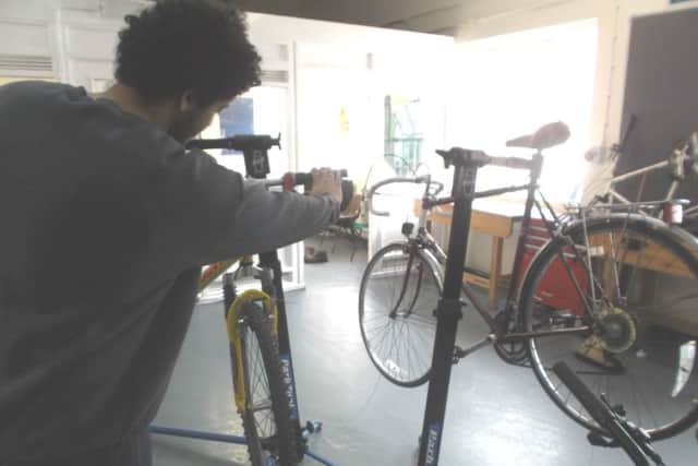 Young prisoners at atÂ HM Young Offenders InstituteÂ in Aylesbury have been repairing bicycles to raise funds to help patients at South Bucks Hospice. A prisoner working on a bike. PNL-160508-152732001