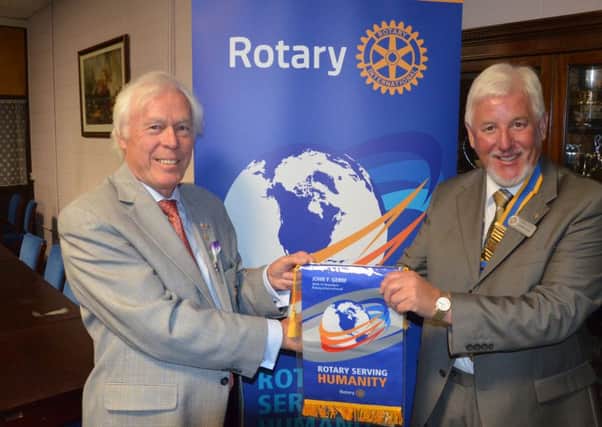 Rotary District for Bucks, Beds & Herts Governor Chalmers Cursley presents Rotary Club of Aylesbury Hundreds President Roger King with a Rotary Serving Humanity banner