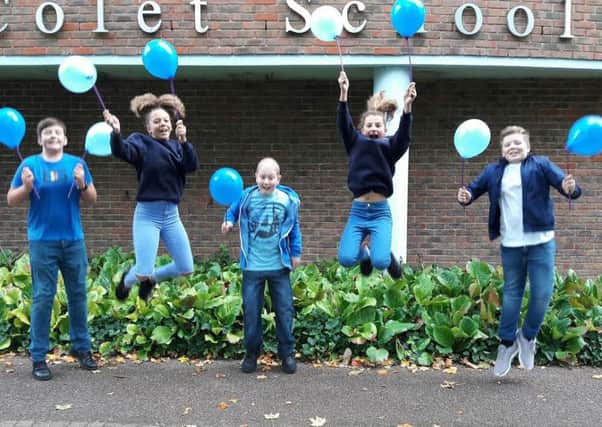 Pupils from John Colet School in Wendover wore blue for the day as part of a fundraiser for Ollie Gardener (pictured centre) PNL-161017-115055001