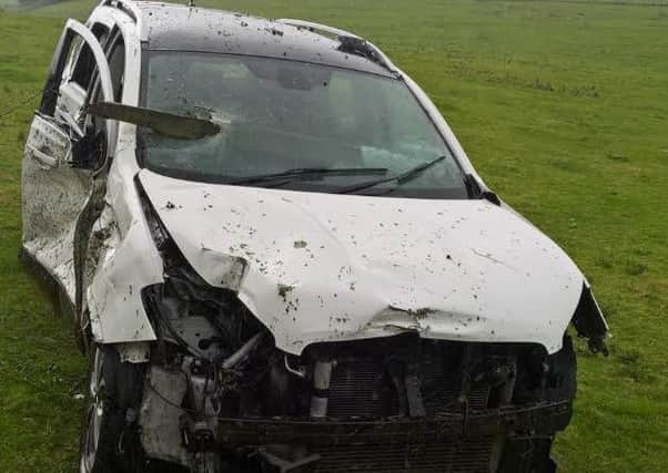 The wreckage of the car badly damaged by fire after an accident on the M40