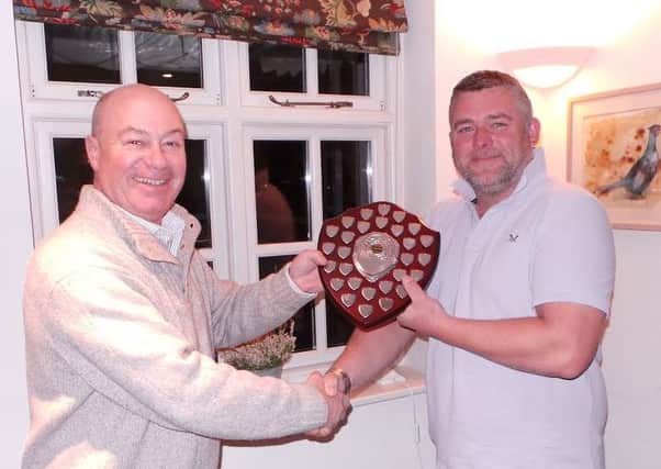 Keith Child from the Rising Sun (left) handing over the shield to this years winning team captain - Mark Wallington from The Pheasant.