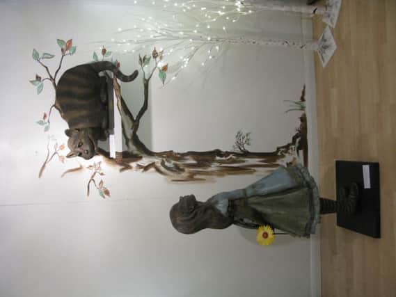 Sculpture of Alice and the Cheshire Cat by Robert James