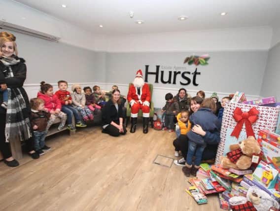 Hurst's collect presents for needy children this Christmas