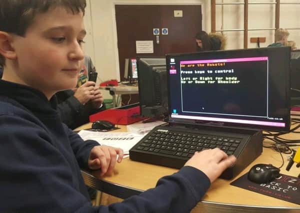A pupil demonstrates computer coding during a workshop at John Hampden School in Thame