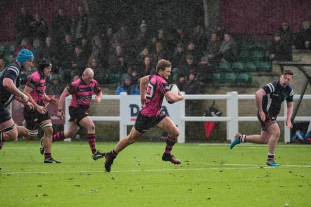 Will Travis sprints through the rain to score his third try Picture: Mark Bannister