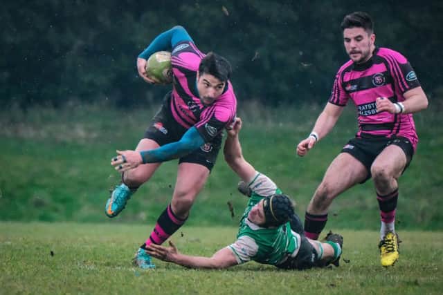Aylesbury's James Serrano evades the tackle of Buckingham's Patrick Ockendon. Picture MarkBannisterPhotography.com