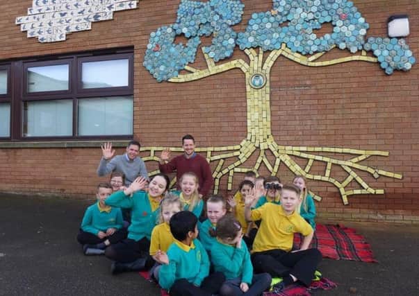 Pupils from Ashmead School in Aylesbury pictured by the new design outside their school entrance