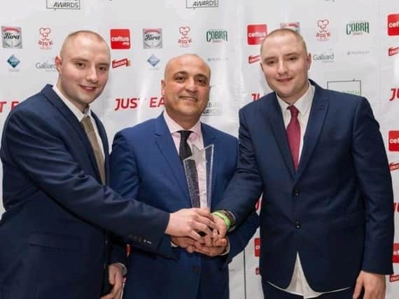 Resul Atalay celebrates victory for his kebab van at the British Kebab Awards with his sons Joshua (left) and Jason (right)