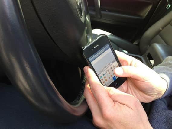 The law changes today regarding use of handheld devices while driving