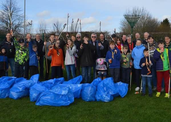 Aylesbury councillors join forces with the local Scouts and Guides units for a big tidy-up of the sports field on Wendover Way