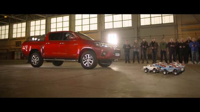 Radio controlled cars tow full size Toyota Hilux in Bicester Photo: SWNS