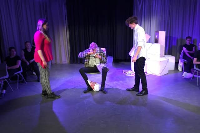 Thame Youth Theatre perform Skellig - in the centre is Skellig (Joe Harrington) watched by Mina (Maya Wakeling) and Michael (Daniel Bottomly)