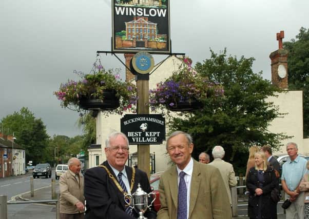 Mayor of Winslow David Barry receives the Pushman Cup in the Best Kept Village awards from Sir Henry Aubrey-Fletcher. Photo from 2013, the last time Winslow won in the event.