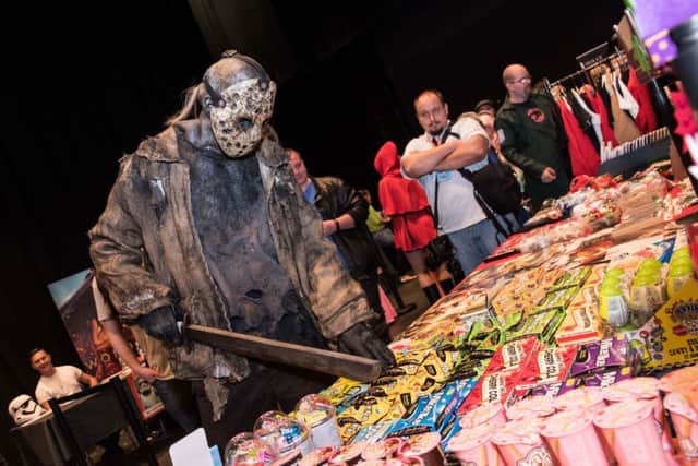A mysterious character browses the sweet table at Comic Con at Aylesbury Waterside Theatre