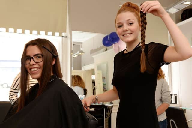 Aoife Finn from Buckingham has her hair cut for The Little Princess Trust, to help her friend, Megan Ponte. Brown's stylist, Aimee Sampson, cutting off plaits.