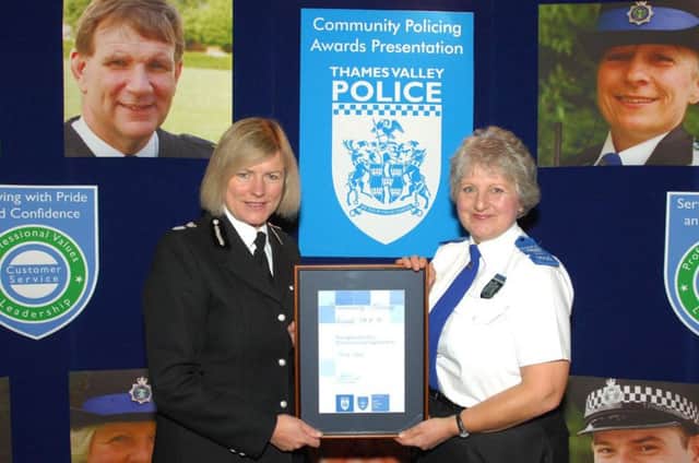 PCSO Wendy Taylor is presented with a certificate to mark her many years of service